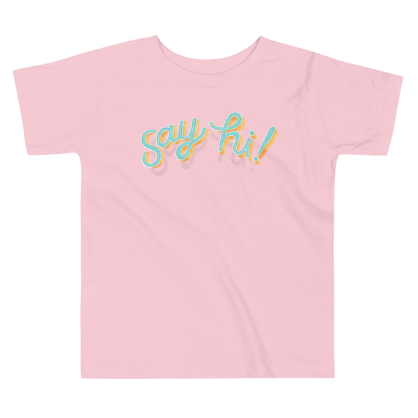 Floating script text "say hi!" on an pink kids t-shirt.