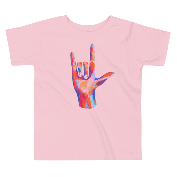 A multicolored and colorful hand signing in ASL  I Love You on a pink kids t-shirt.