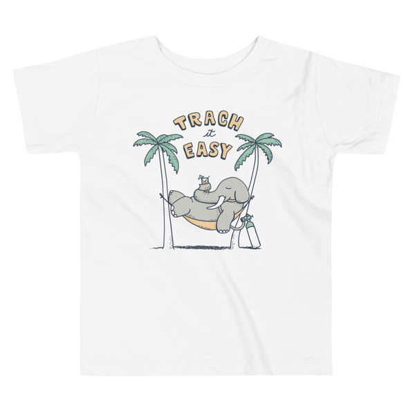 An elephant with a trach or tracheostomy in its stoma and connected to an oxygen tank sits in a hammock between two palm trees with his nose around a drink just trachin’ it easy and relaxing on a white kids t-shirt.
