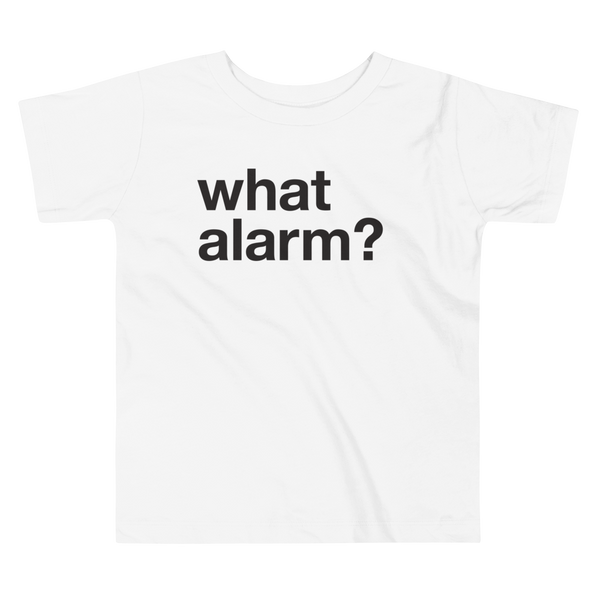 Black text left justified that simply says what alarm? on a white kids t-shirt.