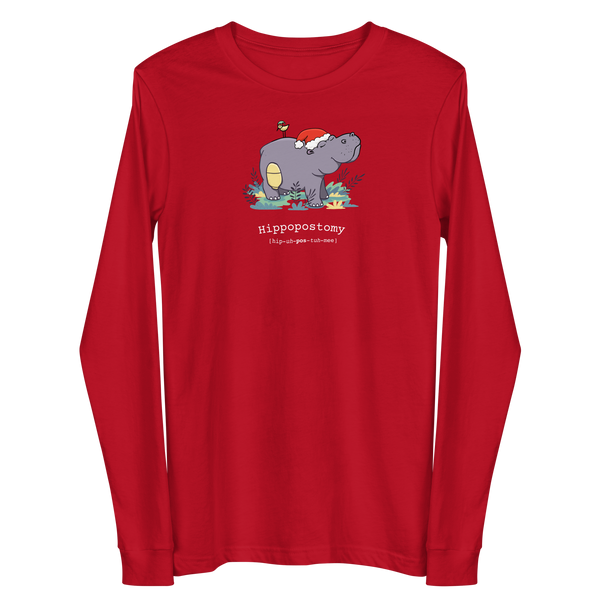 A Hippo or Hippopotamus with an ostomy bag — also known as a Hippopostomy. He is standing in some foliage smiling and has a bird on his back with a Christmas hat on a red adult long sleeve t-shirt.