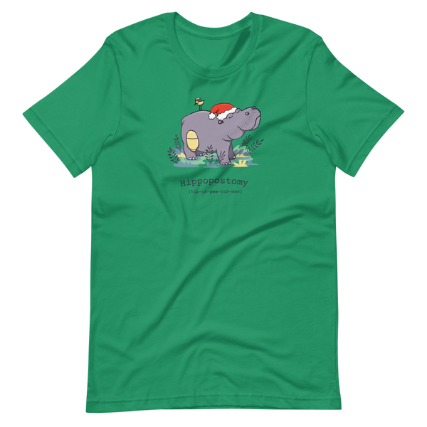 A Hippo or Hippopotamus with an ostomy bag — also known as a Hippopostomy. He is standing in some foliage smiling and has a bird on his back with a Christmas hat on a kelly green adult t-shirt.