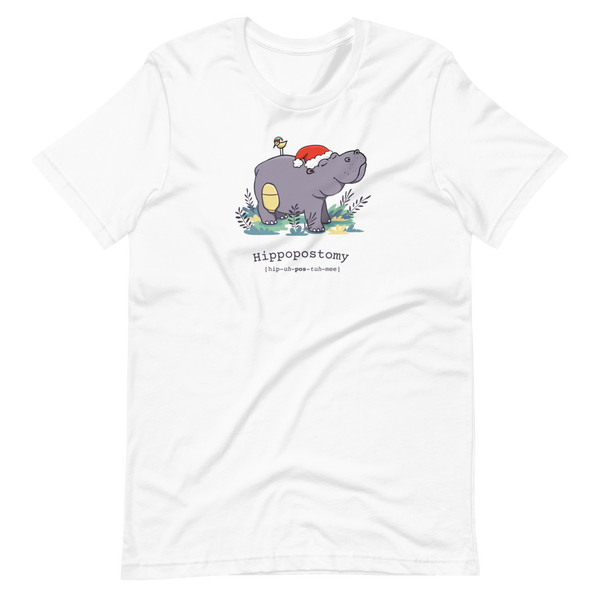 A Hippo or Hippopotamus with an ostomy bag — also known as a Hippopostomy. He is standing in some foliage smiling and has a bird on his back with a Christmas hat on a white adult t-shirt.